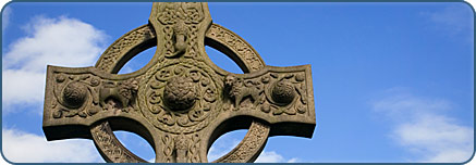 Stone Celtic cross against blue sky