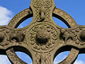 Stone Celtic cross against blue sky